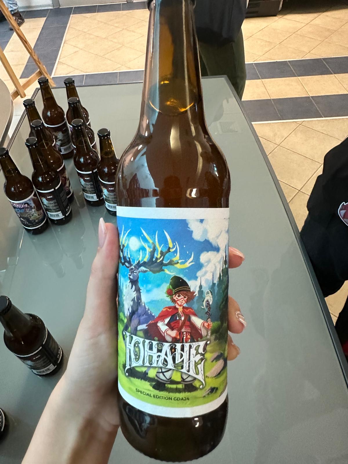 A special-edition beer bottle with Yunache, the game's main character, on the label